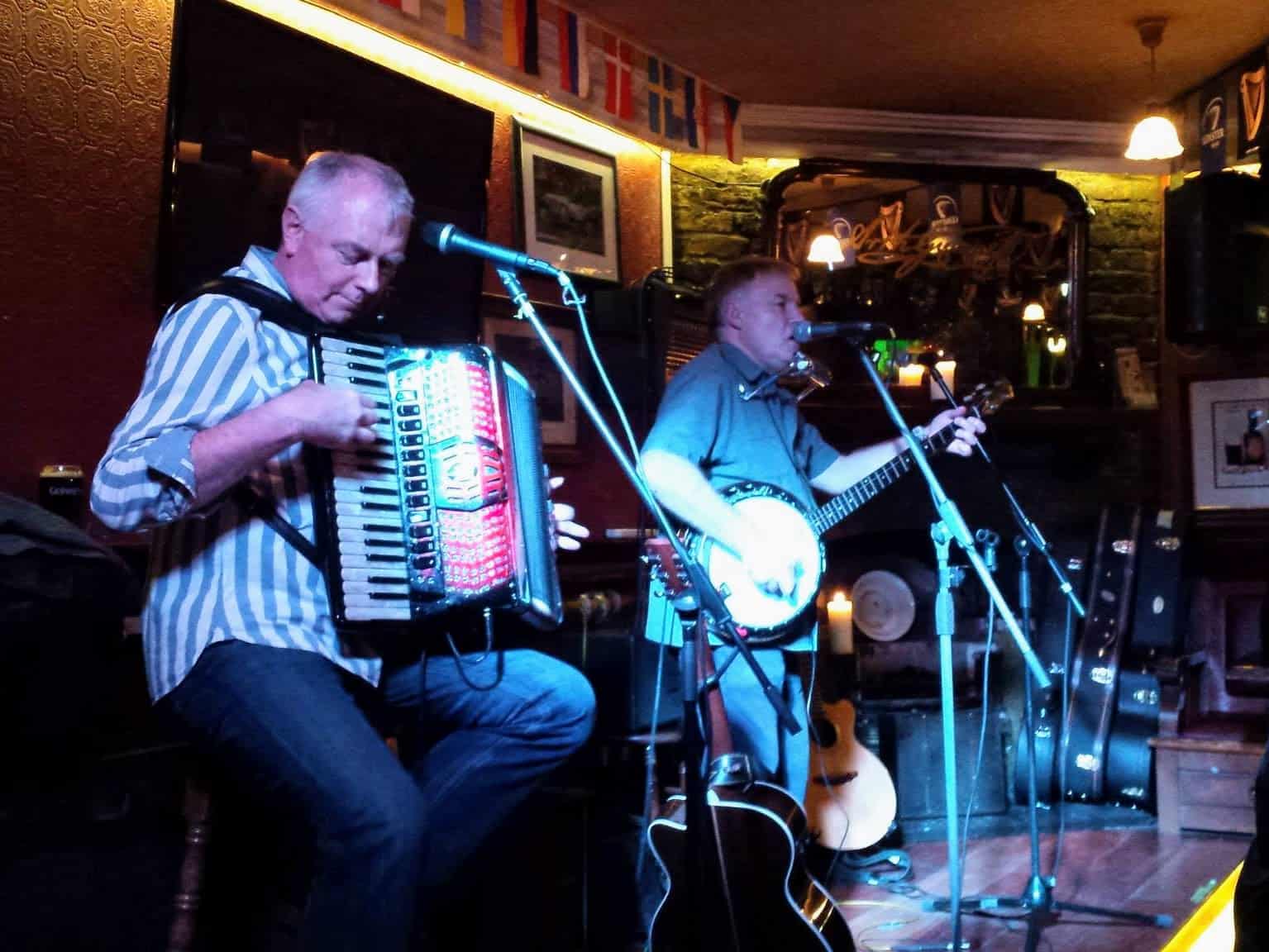 band on stage with accordion and banjo in Ireland pub