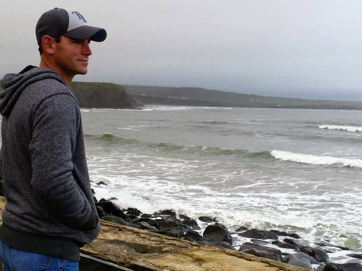 Joe looking out over wild Atlantic Ocean with gray sea and skies