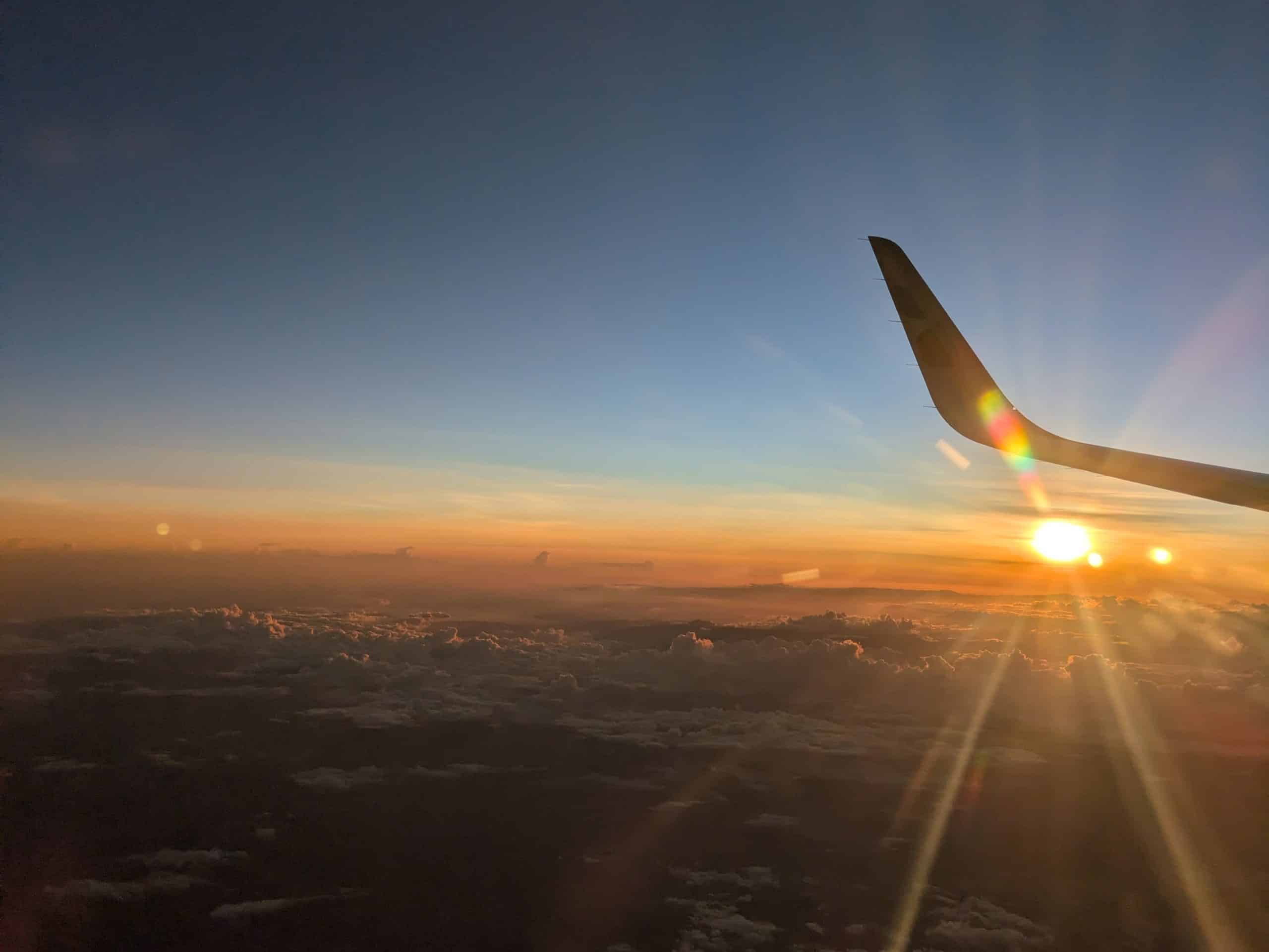 sunrise with airplane wing